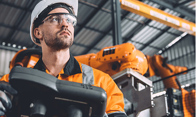 KCE Logistics employee operating tech-driven control unit in an automated warehouse setting.